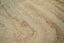 Close-up of dense Egyptian limestone used in John Leighton Dezert furniture, showing its warm sandy tones and tactile bush-hammered texture